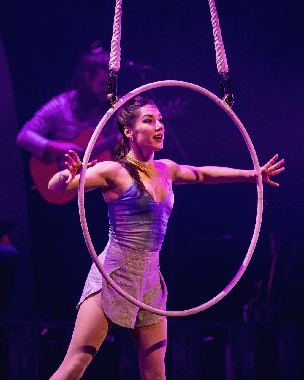 An acrobat performs with an aerial hoop during Cirque Éloize's performance of Entre Ciel et Mer, presented at Place des Arts